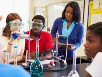 science teacher and students doing experiment